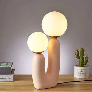 Burdor Table Lamp with a striking pink base and frosted glass shade, offering a sleek, minimalist design. 