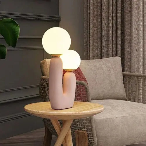 Burdor Table Lamp with a striking pink base and frosted glass shade, offering a sleek, minimalist design. 