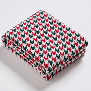 Geometric knitted throw blanket made from 100% polyester, featuring a soft, lightweight, and durable design.