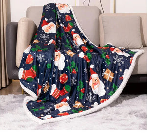 A luxurious Christmas-themed throw blanket featuring flannel on one side and soft white fleece on the other.